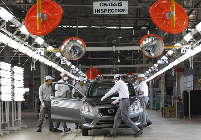 Workers conduct a final inspection of the Datsun Go+ at an assembly line at the Nissan Indonesia factory in Purwakarta. Beawiharta / Reuters