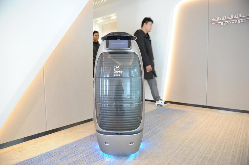 HANGZHOU, CHINA - DECEMBER 17: An intelligent robot serves at Alibaba's first future hotel on December 17, 2018 in Hangzhou, Zhejiang Province of China. Guests living in Alibaba's future hotel can walk into guest rooms, fitness center or restaurant via facial recognition system. Robots are also available in the hotel to provide recorded voice messages and accompany guests during their stay. (Photo by Zhang Yin/China News Service/VCG via Getty Images)