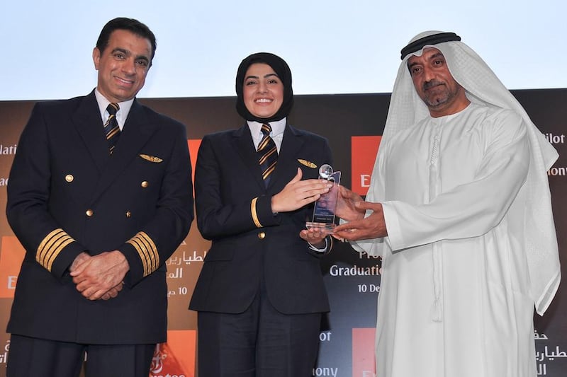 Sheikh Ahmed Bin Saeed Al Maktoum, the chief executive of Emirates, and Captain Nabil Al Boom, the deputy manager for the national cadet pilot programme, present certificates of completion to the graduates of the airline’s training academy. Courtesy Emirates