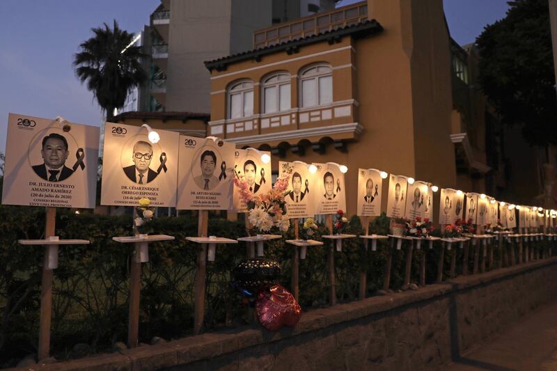 Photos of health workers who died with COVID-19 are displayed on the boardwalk of the Miraflores district in Lima, Peru. EPA