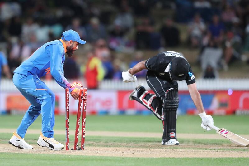 India’s Virat Kohli runs out New Zealand’s Colin de Grandhomme in Hamilton on Wednesday. AFP