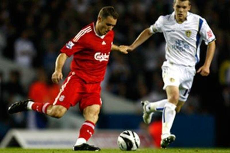 Liverpool's Fabio Aurelio, left, takes on Leeds United's Jonathan Howson in their League Cup clash.