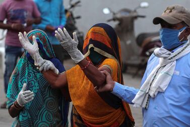 A relative of a patient who died of COVID-19, mourns outside a government COVID-19 hospital in Ahmedabad, India, Tuesday, April 27, 2021. Coronavirus cases in India are surging faster than anywhere else in the world. (AP Photo/Ajit Solanki)