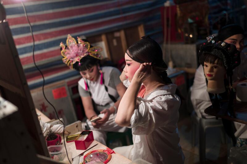 Performers apply their make up before heading out on stage. EPA