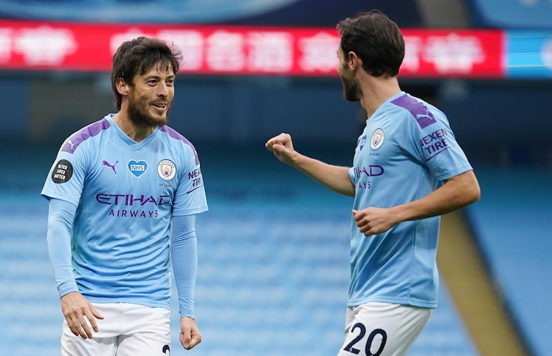 epa08547890 David Silva (L) of Manchester City celebrates with teammate Bernardo Silva after scoring the opening goal during the English Premier League match between Manchester City and AFC Bournemouth in Manchester, Britain, 15 July 2020.  EPA/Dave Thompson/NMC/Pool EDITORIAL USE ONLY. No use with unauthorized audio, video, data, fixture lists, club/league logos or 'live' services. Online in-match use limited to 120 images, no video emulation. No use in betting, games or single club/league/player publications.