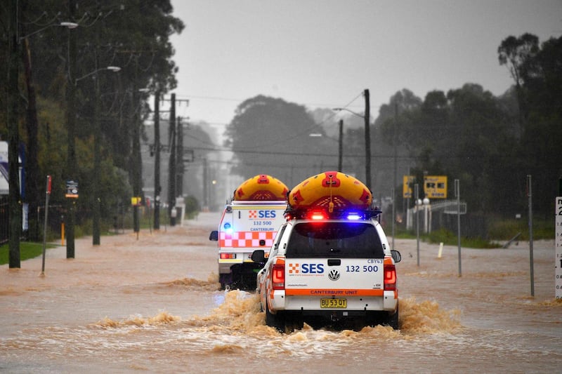 Emergency services vehicles approach flooded residential areas in western Sydney, after residents were ordered to leave low-lying areas along Australia's east coast as torrential rains caused potentially "life-threatening" floods across a region already soaked by an unusually wet summer. AFP