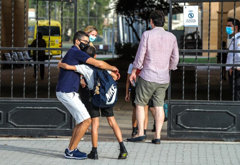 Abu Dhabi, United Arab Emirates, August 30, 2020.  Children return to school on Sunday after months off due to the Covid-19 pandemic at the Brighton College, Abu Dhabi.-  A father and son hug before going back to school.Victor Besa /The NationalSection:  NAReporter:  Haneen Dajani