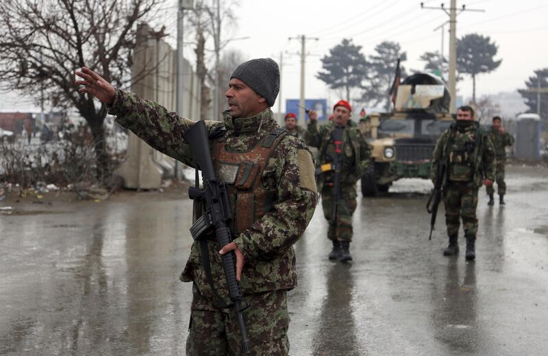Afghan national army soldiers stand guard at the entrance gate of the Marshal Fahim military academy in Kabul, Afghanistan, Monday, Jan. 29, 2018. Militants attacked an Afghan army unit guarding the military academy on Monday, officials said. Hours later, the Islamic State group claimed responsibility for the assault. (AP Photo/Rahmat Gul)