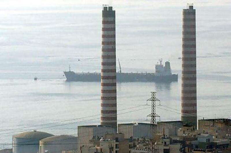 A tanker carrying fuel oil passes by the oil refinery near Zouk, Lebanon. EPA / WAEL HAMZEH