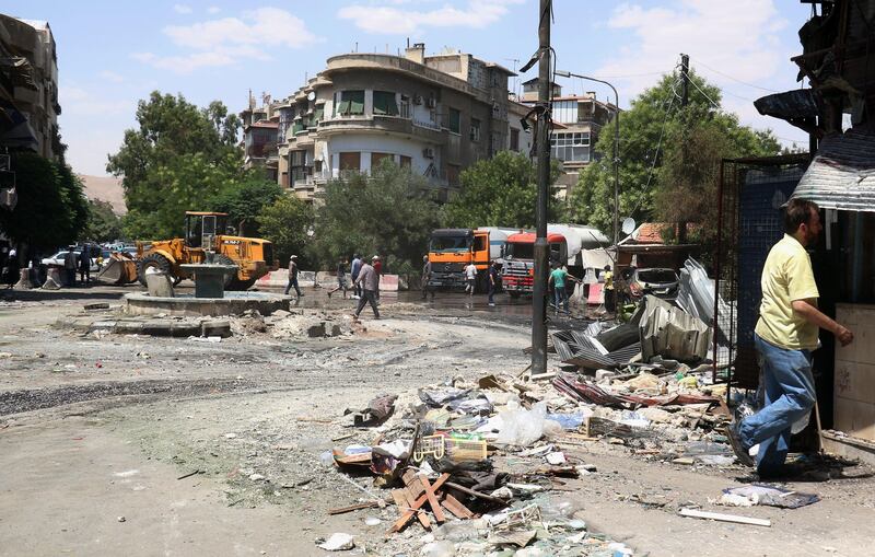 epa06061475 A general view of damage caused by a car bomb explosion near the al-Ghadir Square in the al-Amara neighborhood in Damascus, Syria, 02 July 2017. According to the state TV, three car bomb blasts rocked the capital  Damascus on 02 July that killed at least eight people and wounded a dozen others. It said that three car bombs went off at the Airport Road and al-Amara neighborhood in Damascus city. It indicated that the authorities chased the three cars and managed to intercept two of them near the entrance of Damascus city at the airport roundabout and destroyed them, but the third car managed to arrive in the capital and the suicide bomber on board detonated it, killing a number of people and injuring others.  EPA/YOUSSEF BADAWI