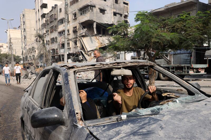 A man drives a damaged car following air strikes on Gaza city. AFP