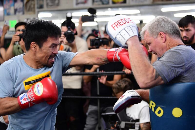 Eight-division world champion boxer Manny Pacquiao spars with coach Freddy Roach. AFP