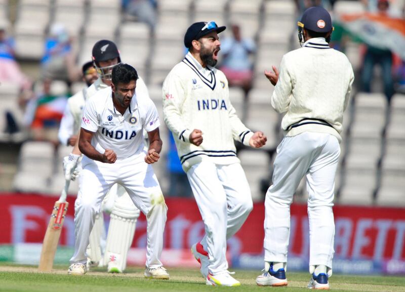 India's Ravichandran Ashwin, left, and teammates celebrate the dismissal of New Zealand's Devon Conway. AP