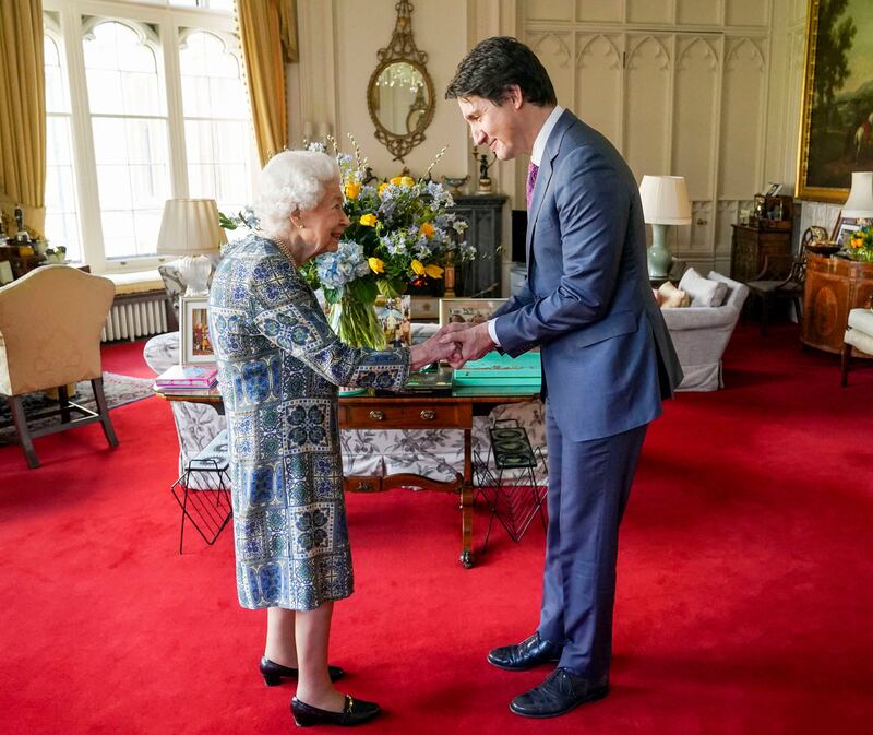 Queen Elizabeth shakes hands with Canadian Prime Minister Justin Trudeau as they meet for an audience at Windsor Castle in March 2022. AFP