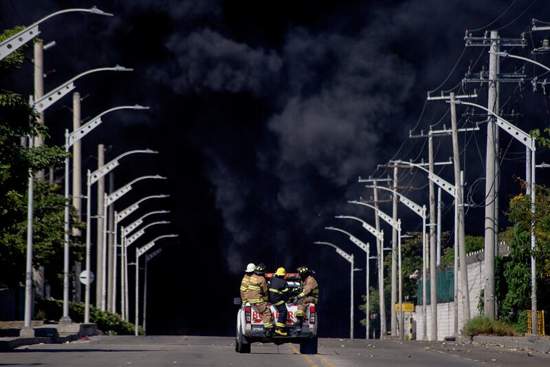 Firefighters head to contend with a blaze at a hydrocarbon storage area of Bravo Petroleum company in Barranquilla, Colombia. Reuters