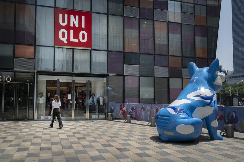 A pedestrian walks past a Uniqlo store, operated by Fast Retailing Co., in the Sanlitun area in Beijing, China, on Wednesday, July 15, 2020. The Chinese economy returned to growth in the second quarter, marking an important milestone in the global struggle to recover from the coronavirus pandemic. Photographer: Giulia Marchi/Bloomberg