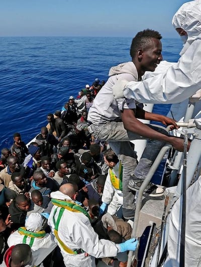 Migrants are rescued by an Italian coastguard boat in the Mediterranean. Alessandro Di Meo / EPA