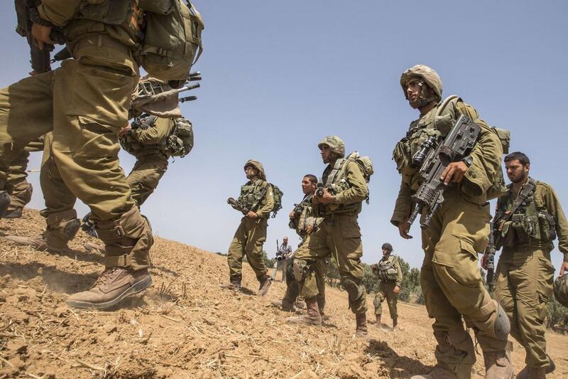 Israel's army will begin on Tuesday a massive exercise simulating conflict with Hizbollah. In this photo, taken on September 22, 2014, Israeli soldiers walk at an Israeli deployment area near the border with the Gaza Strip. Jack Guez / AFP
