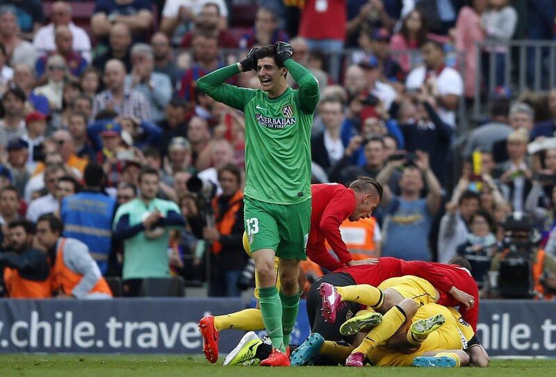 Atletico Madrid goalkeeper Thibaut Courtois reacts after the team wins the La Liga title on Saturday. Marcelo del Pozo / Reuters / May 17, 2014