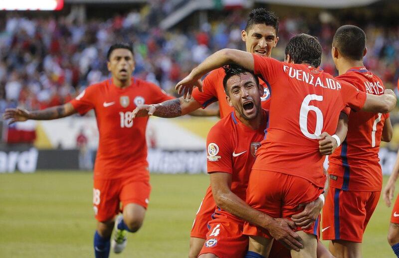 Chile's Jose Pedro Fuenzalida (6) celebrates his goal as he jumps in the arms of Mauricio Isla (4) during a Copa America Centenario semifinal soccer match against Colombia, at Soldier Field in Chicago, Wednesday, June 22, 2016. (AP Photo/Charles Rex Arbogast)