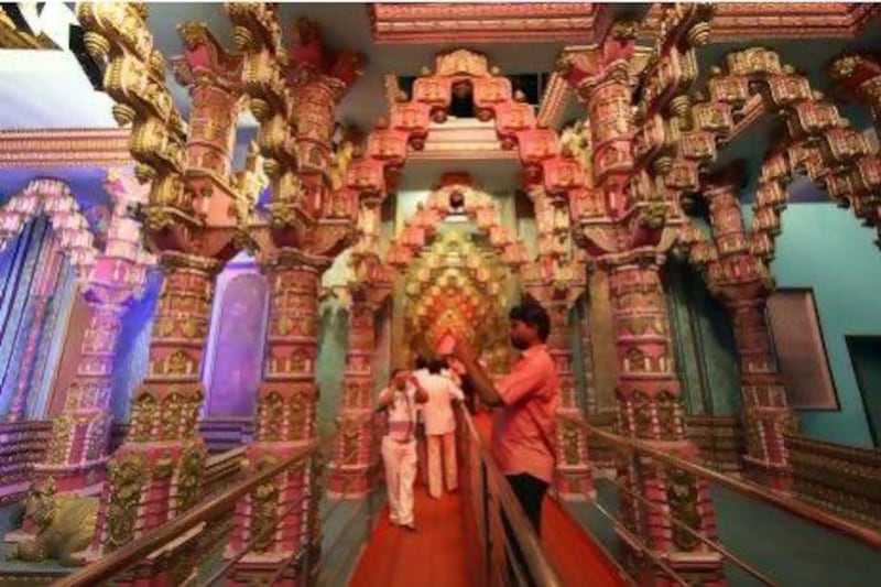 Visitors take pictures at the ‘King’s Court’ set in Ramoji, the world's largest film production complex.