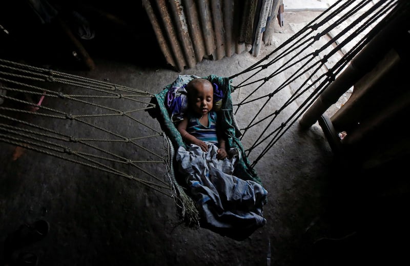 An infant sleeps in a hammock at a shelter in Kolkata, India. Rupak De Chowdhuri / Reuters
