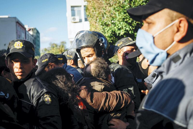 Police shoving protesters after deploying tear gas. Erin Clare Brown / The National