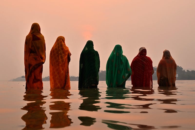 Hindu worshippers offer prayers on the banks of Brahmaputra during a festival in Guwahati, India. AFP
