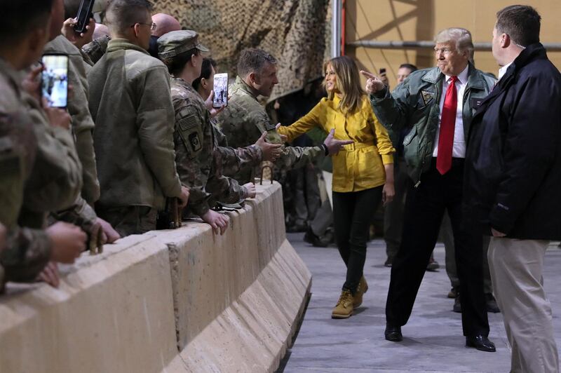 US President Donald Trump, with first lady Melania Trump, arrives to deliver remarks to US troops in an unannounced visit to Al Asad Air Base, Iraq. Reuters