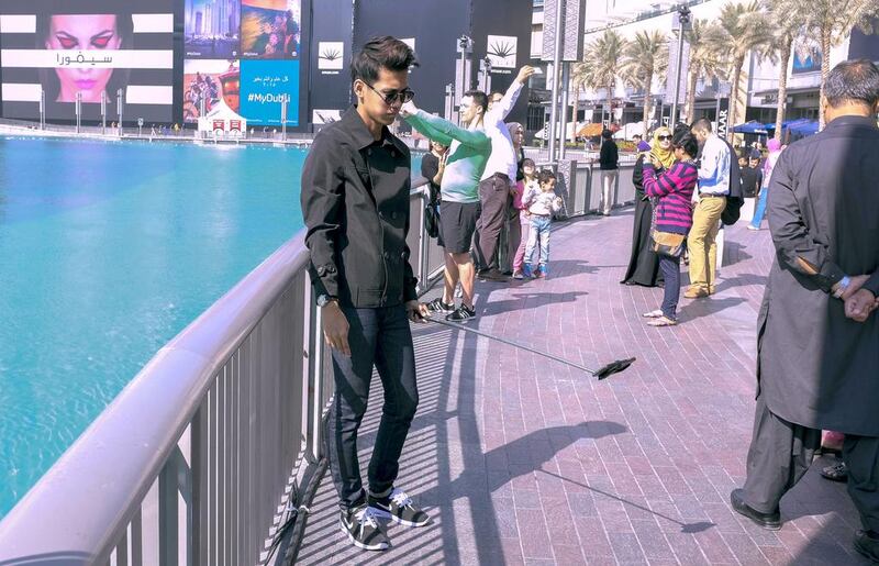 A tourist uses a selfie stick to photograph himself outside The Dubai Mall. Antonie Robertson / The National 