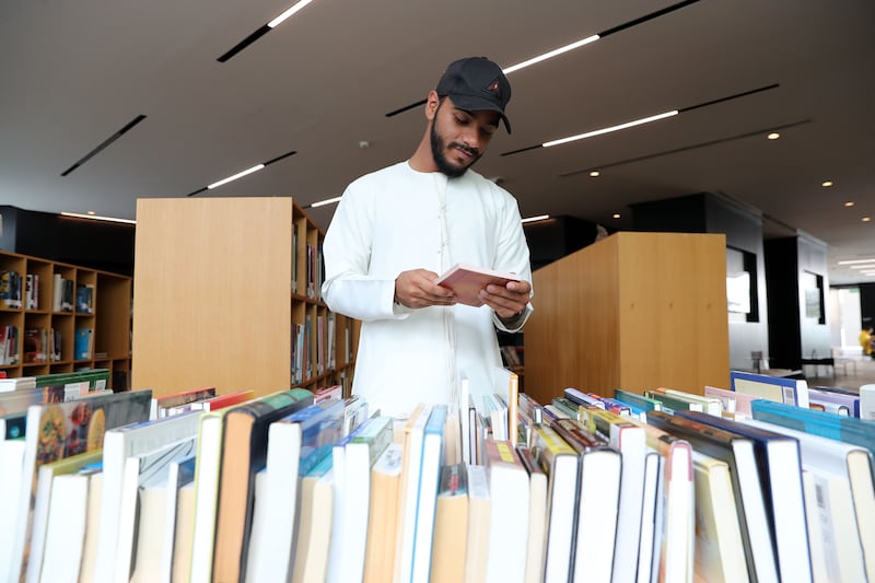 Mohammed Faisal looks through books at the event 