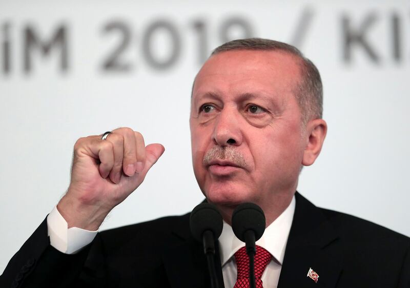 Turkey's President Recep Tayyip Erdogan, talks to to supporters during an event in Ankara, Turkey, Saturday, Oct. 5, 2019. Erdogan threatened Saturday to launch a solo military operation into northeastern Syria, where U.S. troops are deployed and have been trying to defuse tension between its NATO ally and Syrian Kurdish forces. (Presidential Press Service via AP, Pool)