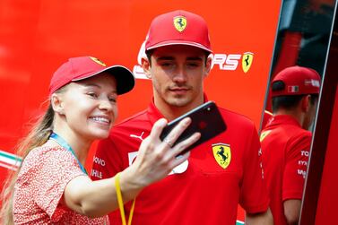 Ferrari driver Charles Leclerc poses for a photo with a fan at the Marina Bay Circuit ahead of the Singapore Grand Prix. EPA