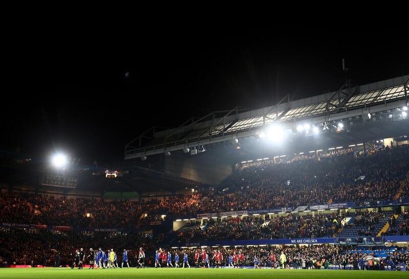 The teams walk out onto the Stamford Bridge pitch prior to kick off. Catherine Ivill / Getty Images