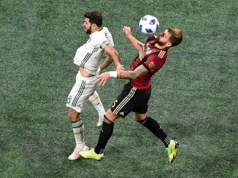 Atlanta United's Leandro Gonzalez Pirez goes up for a header against Portland Timbers' Diego Valeri. Reuters