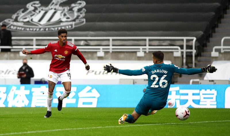 NEWCASTLE UPON TYNE, ENGLAND - OCTOBER 17: Marcus Rashford of Manchester United scores his team's fourth goal past Karl Darlow of Newcastle United during the Premier League match between Newcastle United and Manchester United at St. James Park on October 17, 2020 in Newcastle upon Tyne, England. Sporting stadiums around the UK remain under strict restrictions due to the Coronavirus Pandemic as Government social distancing laws prohibit fans inside venues resulting in games being played behind closed doors. (Photo by Alex Pantling/Getty Images)
