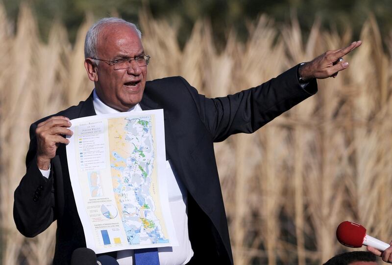 Palestinian chief negotiator Saeb Erekat holds a map as he speaks to media about the Israeli plan to appropriate land, in Jordan Valley near the West Bank city of Jericho, on January 20, 2016. Reuters