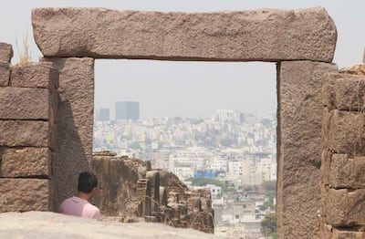 A tourist looking at the city of Hyderabad from the Golconda Fort. It rests on a granite hill 120m high as huge crenulated ramparts surround this structure. Taniya Dutta / The National