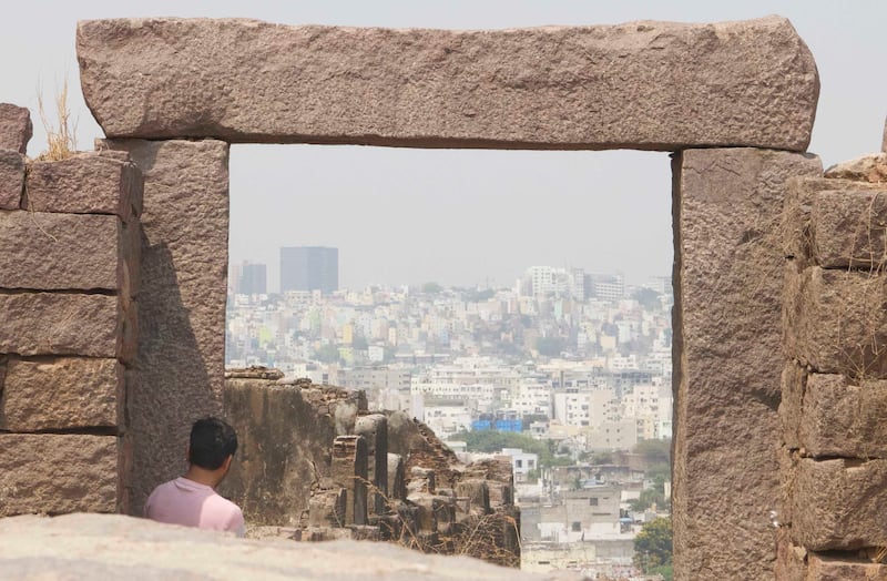 A tourist looks at the city of Hyderabad from Golconda Fort