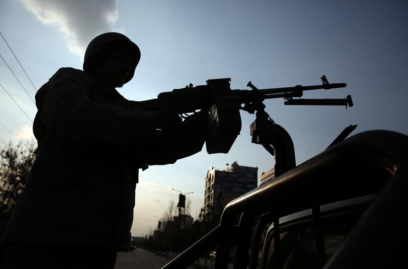 An Afghan security personnel stand guard after an attack in Kabul, Afghanistan, Friday, March 6, 2020. Gunmen in Kabul attacked a remembrance ceremony for a minority Shiite leader on Friday, wounding several people, officials said. (AP Photo/Tamana Sarwary)