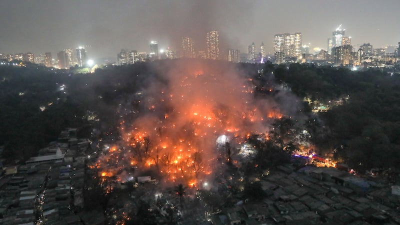 Smoke billows from a fire at the Appapada slums in Mumbai. EPA

