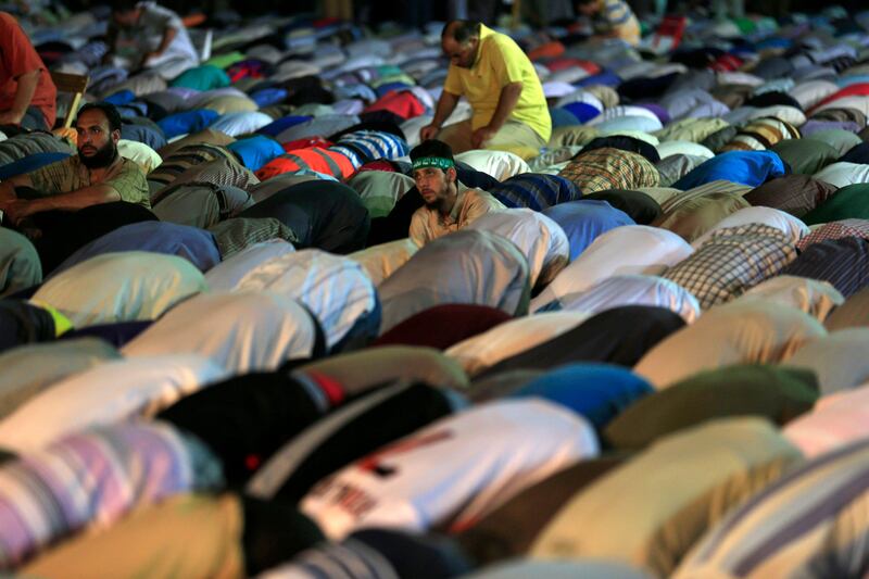 Supporters of Egypt's ousted President Mohammed Morsi pray at Nasr City, where protesters have installed a camp and hold daily rallies, in Cairo, Egypt, Sunday, July 28, 2013. Escalating the confrontation after clashes that left more than 80 supporters of Egypt's ousted Islamist president dead, the interim government moved Sunday toward dismantling two pro-Mohammed Morsi sit-in camps, accusing protesters of "terrorism" and vowing to deal with them decisively. (AP Photo/Hassan Ammar) *** Local Caption ***  Mideast Egypt.JPEG-01d5d.jpg