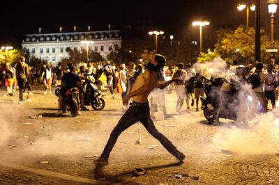 PARIS, FRANCE - JULY 15: French football fans clash with police following celebrations around the Arc de Triomph after France's victory against Croatia in the World Cup Final on July 15, 2018 in Paris, France. France beat Croatia 4-2 in the World Cup Final played at Moscow's Luzhniki Stadium today. (Photo by Jack Taylor/Getty Images)