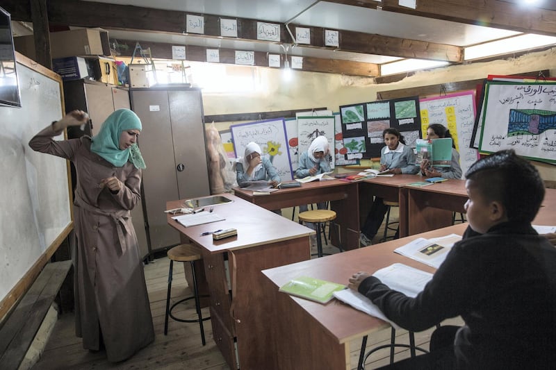 Beduin children in a history class at the elementary school in the tiny West Bank Beduin village of Khan al-Ahmar  on May 2,2018.The Israeli Supreme Court is expected next week to rule on the fate of the village, situated east of Jerusalem between the expanding settlements of Maale Adumim and Kfar Adumim.  The Israeli state says Khan al-Ahmar must be leveled because its structures are situated on state land and were built without permits, which are nearly impossible to obtain in the part of the West Bank known as area C, under full Israeli control.(Photo by Heidi Levine for The National).