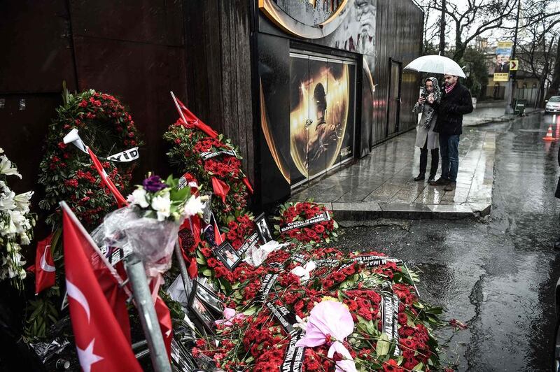 People take pictures of a makeshift memorial set up in front of the Reina nightclub on January 5, 2017 in Istanbul, four days after a gunman killed 39 people during New Year clebrations. Ozan Kose / AFP