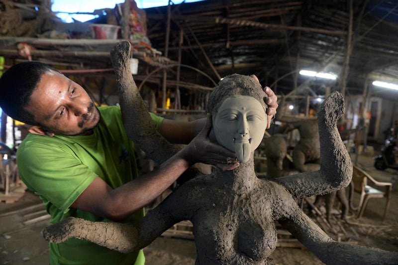 An artisan works on an idol of the goddess Kali on the outskirts of Hyderabad. AFP