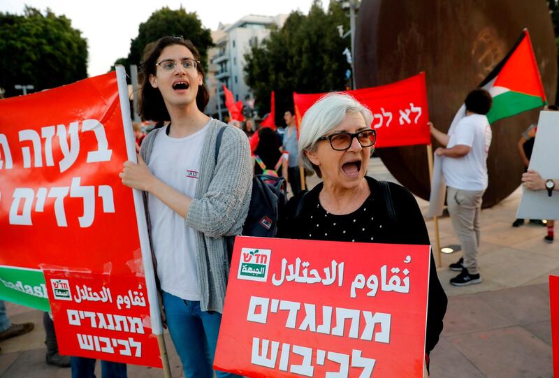 Left wing Israelis hold slogans during a protest against Eurovision in Tel Aviv. While Israel's 2018 Eurovision victory with Netta Barzilai's "Toy" meant the Jewish state would host the next year. 
 AFP