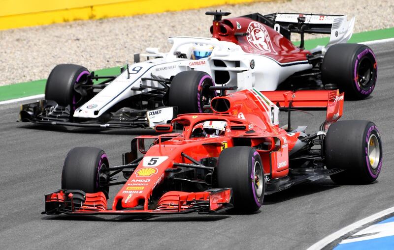 Ferrari driver Sebastian Vettel of Germany, front, and Sauber driver Marcus Ericsson of Sweden steer their cars during the qualifying session at the Hockenheimring racetrack in Hockenheim, Germany, Saturday, July 21, 2018. The German Formula One Grand Prix will be held on Sunday, July 22, 2018. (AP Photo/Jens Meyer)