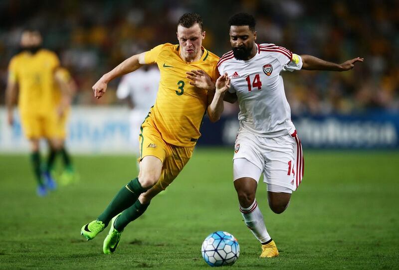 Australia's Brad Smith competes for the ball against the UAE's Abdulaziz Sanqour in Sydney. Matt King / Getty Images