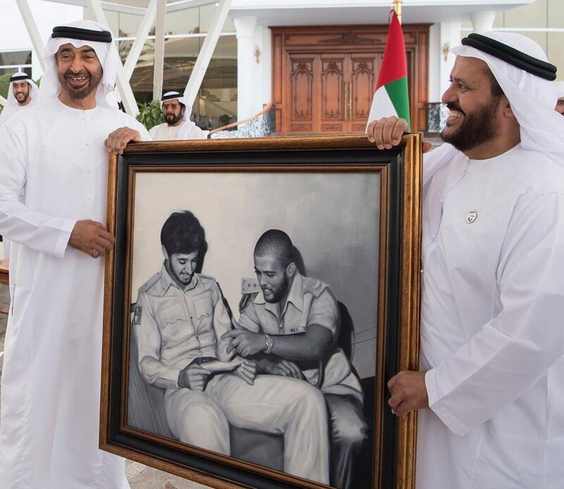 Sheikh Mohamed bin Zayed, Crown Prince of Abu Dhabi and Deputy Supreme Commander of the Armed Forces, receives a photo from retired Maj Gen Khalifa Al Mazrouei during a Sea Palace Barza on Tuesday. Courtesy Sheikh Mohamed bin Zayed Instagram